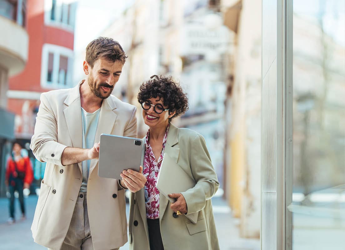 Teamwork or Two Partnership Work Together Concept. Businessman and Business Woman Working on Tablet outside the Office. Chasing after success with the best connection